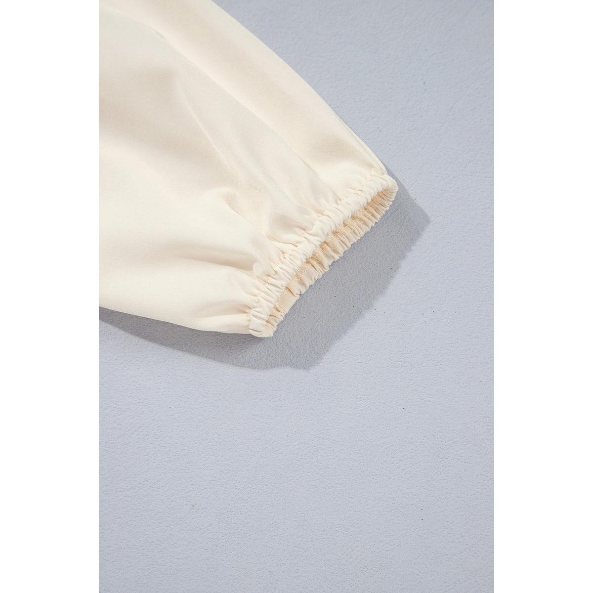 Ivory Smocked Blouse with Balloon Sleeves in Jet Stream - cuff detail